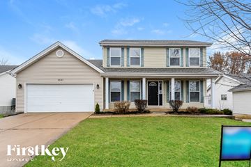 O'fallon house for rent - a beige house with a white garage door