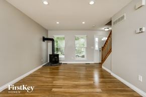 O'fallon house for rent - a living room with a wood floor and a fireplace