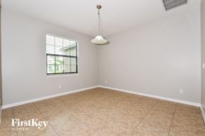 Cape Coral house for rent - the living room of a home with a large window and tiled floors
