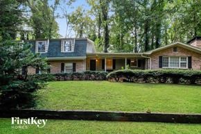 Stone Mountain house for rent - A house with a green lawn and trees in the background.