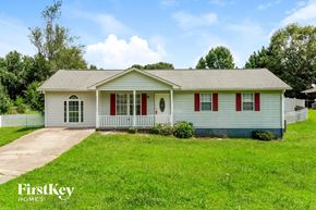 Clermont house for rent - a small white house with red shutters and a lawn
