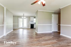 Clermont house for rent - an empty living room with a ceiling fan and a kitchen