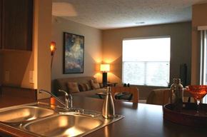Council Bluffs apartment for rent - A kitchen with a stainless steel sink and a red glass bowl on the counter.