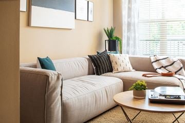 Council Bluffs apartment for rent - A living room with a beige couch and a coffee table.