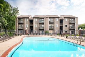 Council Bluffs apartment for rent - A large swimming pool in front of apartment buildings.