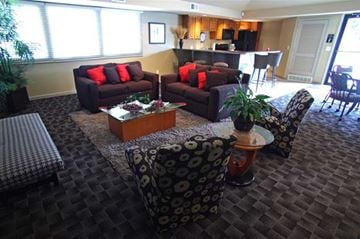 Omaha apartment for rent - A living room with a brown couch and a coffee table.