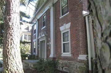 Philadelphia apartment for rent - a brick house with a tree in front of it