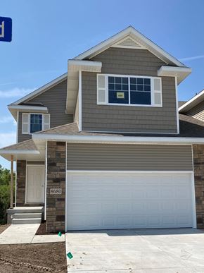 Lincoln house for rent - a gray house with a white garage door