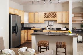 Omaha apartment for rent - a kitchen with stainless steel appliances and wooden cabinets