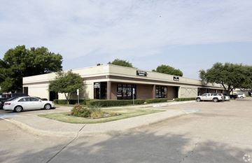 Dallas apartment for rent - A building with a parking lot in front of it.
