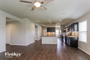Conroe house for rent - an open kitchen and living room with a ceiling fan