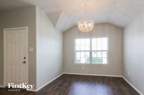 Conroe house for rent - an empty room with a window and a white door