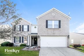 Plainfield house for rent - A brick house with a garage door is for sale.