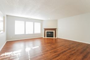 Plainfield house for rent - A room with a fireplace and wood flooring.