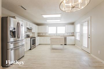 Plainfield house for rent - A kitchen with a refrigerator, oven, and microwave.