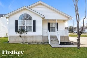 La Vergne house for rent - A white house with a black window and a tree in front.