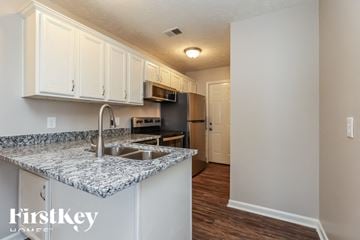 La Vergne house for rent - A kitchen with a granite countertop and a refrigerator.