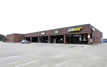 Dallas apartment for rent - A Subway restaurant with a car parked in front.