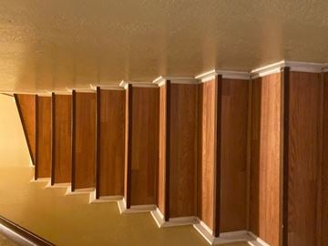 Killeen apartment for rent - a living room with wood paneling on the wall and a staircase