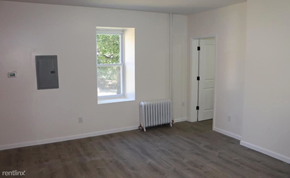 Philadelphia apartment for rent - an empty room with a radiator and a window