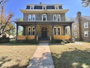 Philadelphia apartment for rent - a brick house with a porch and a sidewalk