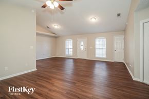 Jacksonville house for rent - the living room with hardwood flooring and a ceiling fan