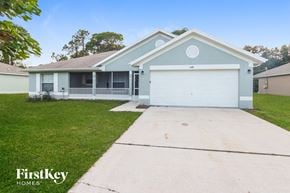 Palm Bay house for rent - A two-story house with a garage is for sale.