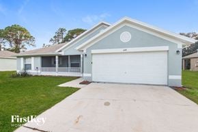 Palm Bay house for rent - A house with a garage and a driveway in front of it.