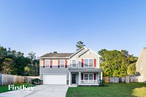 Summerville house for rent - a gray house with red shutters and a white garage door