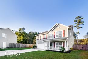Summerville house for rent - a white house with red shutters and a yard with grass
