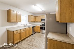 Summerville house for rent - a kitchen with wooden cabinets and stainless steel appliances