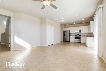 Vail house for rent - A spacious kitchen and living room with a ceiling fan and beige tiled floors.