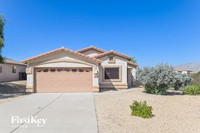 Tucson house for rent - a house with a driveway and a garage door