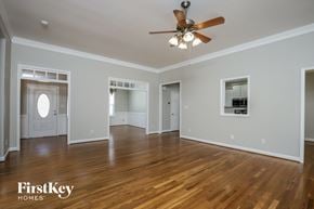 Kernersville house for rent - an empty living room with wood floors and a ceiling fan