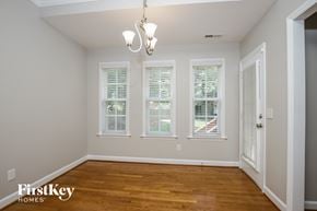 Kernersville house for rent - a dining room with a wood floor and three windows