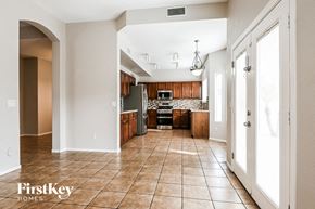 Peoria house for rent - a kitchen with wooden cabinets and tile flooring