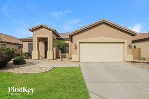 Goodyear house for rent - a house with a driveway and a garage door