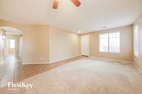 Goodyear house for rent - a empty living room with a door and a window