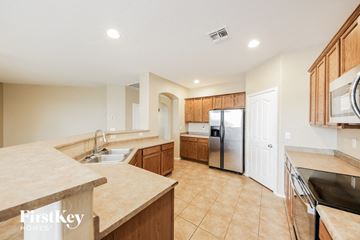 Goodyear house for rent - a large kitchen with a sink and a refrigerator