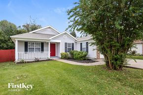 Antioch house for rent - A white house with a red door and a tree in front.