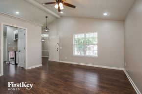 Antioch house for rent - A spacious room with a ceiling fan and wooden flooring.