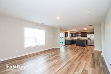 Lexington house for rent - a kitchen and living room with wood flooring and a large window