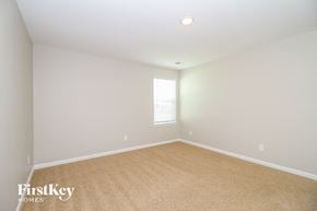 Lexington house for rent - a bedroom with a carpeted floor and a window