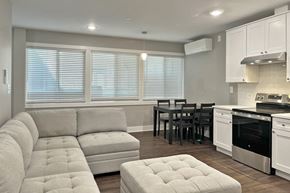 Oak Park apartment for rent - A modern kitchen with a white sofa and a dining table.