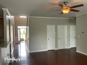 Indian Trail house for rent - A room with a ceiling fan and four doors.