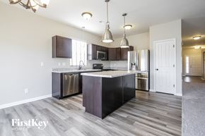 Indianapolis house for rent - a kitchen with stainless steel appliances and a marble counter top