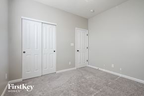 Indianapolis house for rent - a bedroom with two doors and a carpeted floor