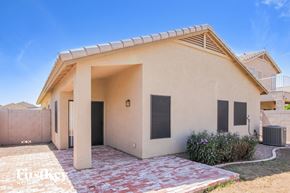 Peoria house for rent - A small beige house with a red brick walkway in front.