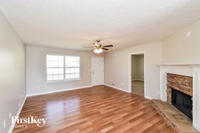 Temple house for rent - a living room with a fireplace and a ceiling fan