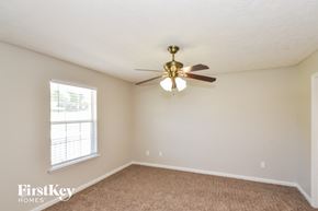 Temple house for rent - a bedroom with a ceiling fan and a window